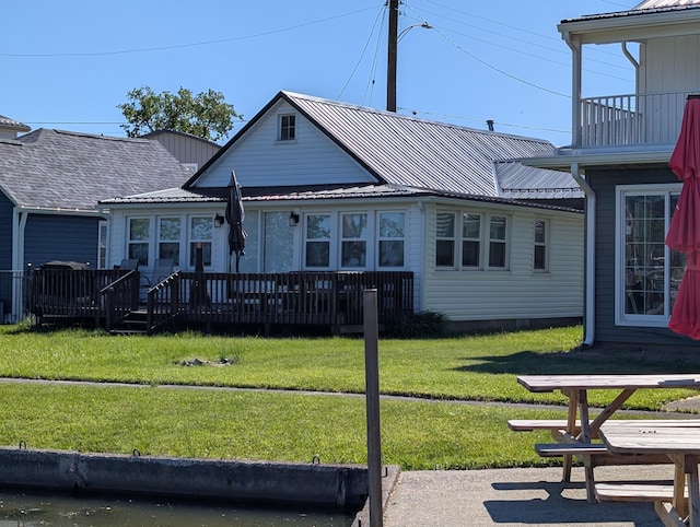 127 Brads Way, Russells Point, OH 43348 - view of front of home with a front lawn, a wooden deck, and a metal roof