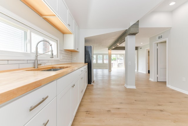 127 Brads Way, Russells Point, OH 43348 - kitchen featuring backsplash, light wood-type flooring, white cabinets, recessed lighting, and wood counters