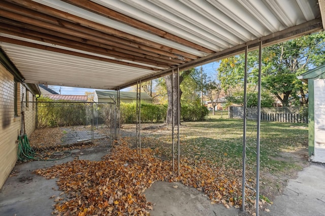 view of yard featuring a carport and a fenced backyard