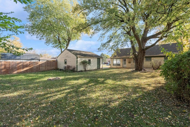 view of yard with an outbuilding and fence