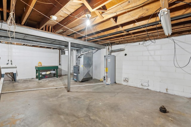 unfinished basement featuring gas water heater and heating unit