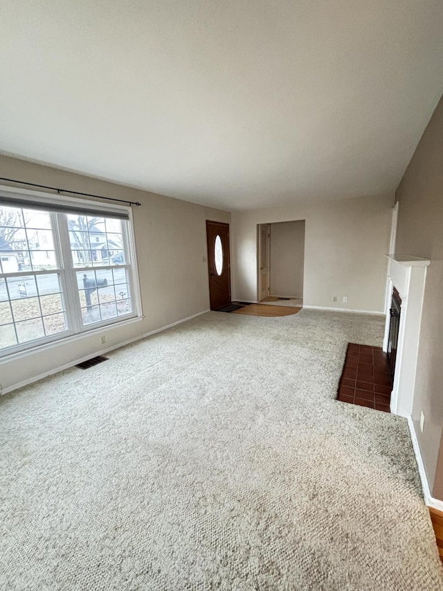 unfurnished living room with carpet flooring