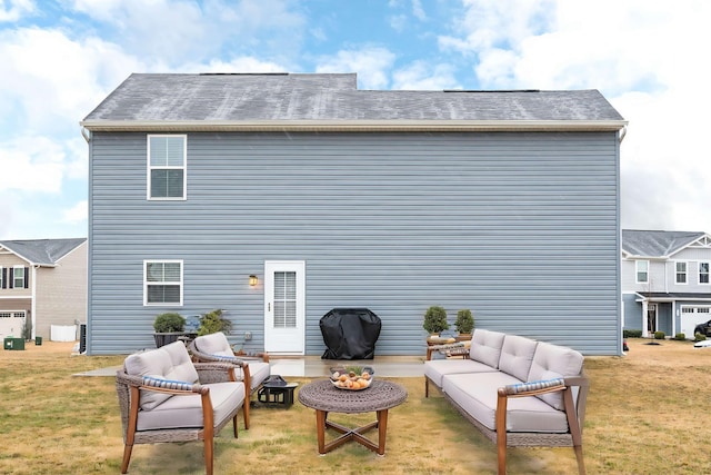 rear view of house with outdoor lounge area and a yard