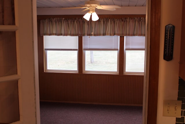 carpeted empty room featuring plenty of natural light and ceiling fan