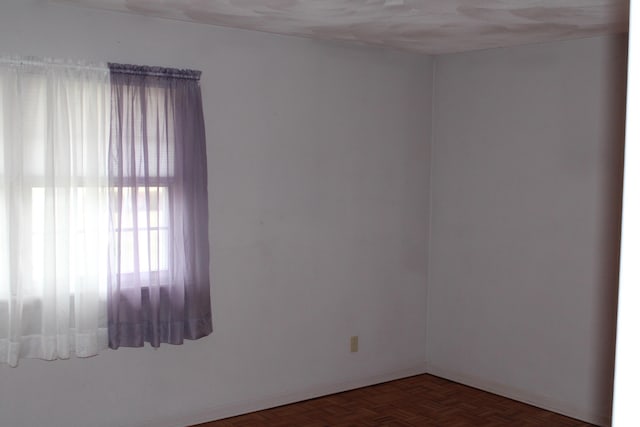 unfurnished room with dark parquet floors