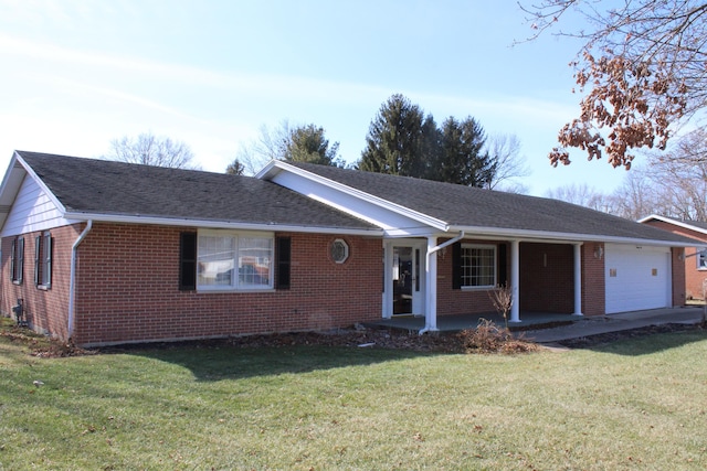 ranch-style house featuring a garage, a front yard, and covered porch