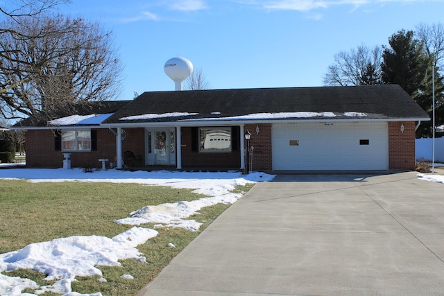 ranch-style house with a garage and a yard