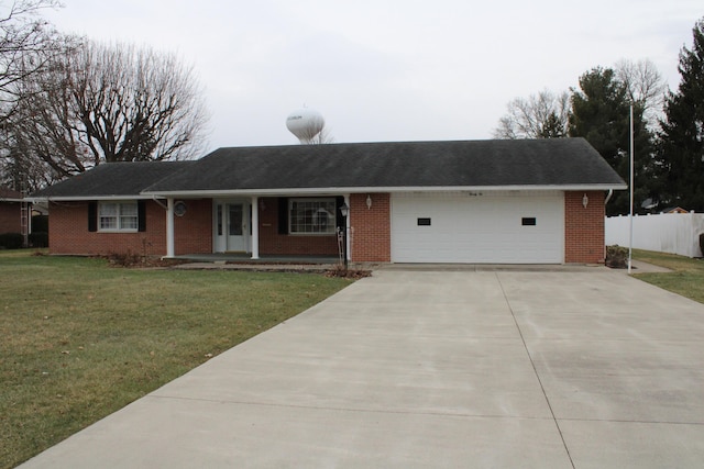 ranch-style home featuring a garage and a front yard