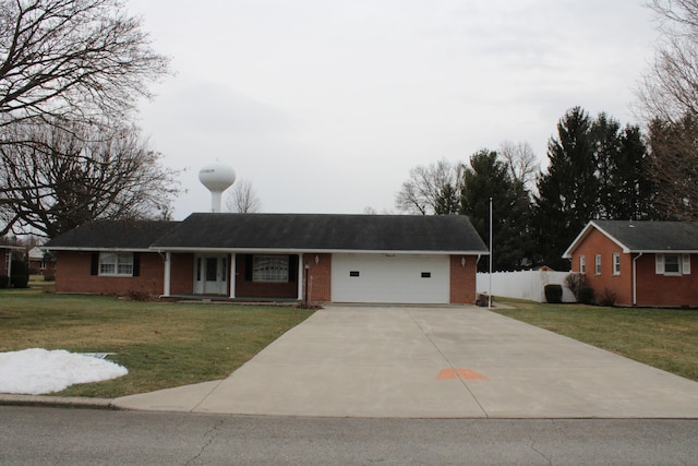 ranch-style house with a garage and a front yard