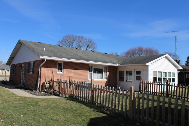 rear view of property with a yard