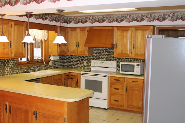 kitchen featuring sink, white appliances, custom range hood, decorative light fixtures, and kitchen peninsula