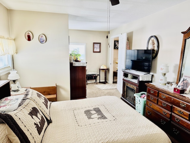 carpeted bedroom with multiple windows and ceiling fan