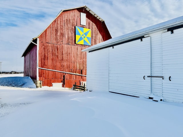 snow covered property featuring an outdoor structure