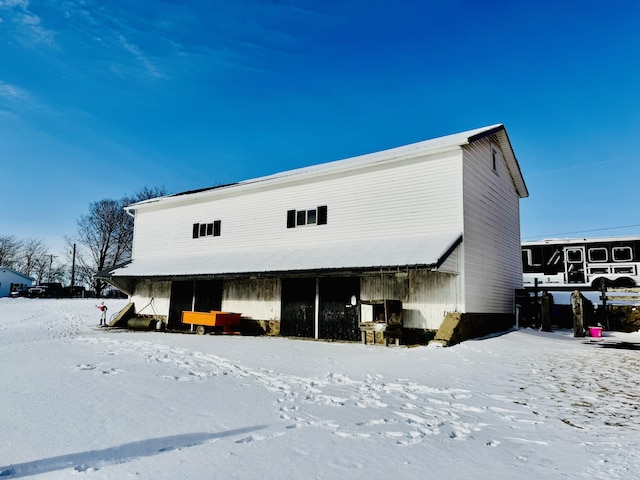 view of snow covered rear of property