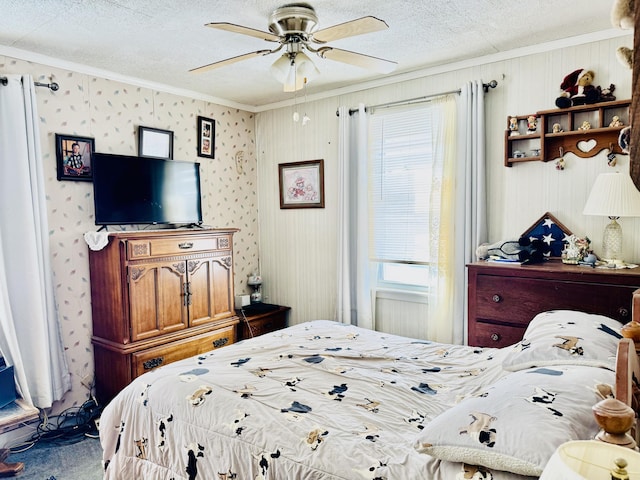 carpeted bedroom featuring crown molding, ceiling fan, and a textured ceiling