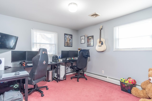 office area with baseboard heating, visible vents, and carpet floors