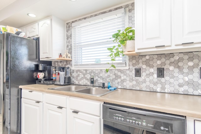 kitchen featuring white cabinetry, black appliances, light countertops, and a sink