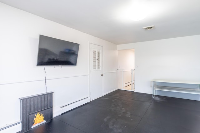 unfurnished living room with concrete floors, a baseboard heating unit, visible vents, and a baseboard radiator