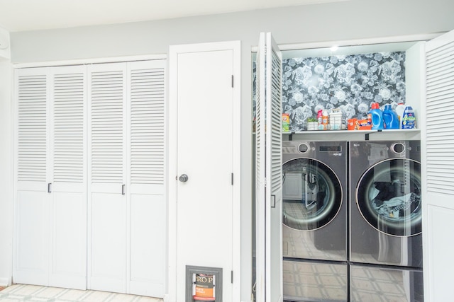 clothes washing area featuring laundry area and washer and clothes dryer