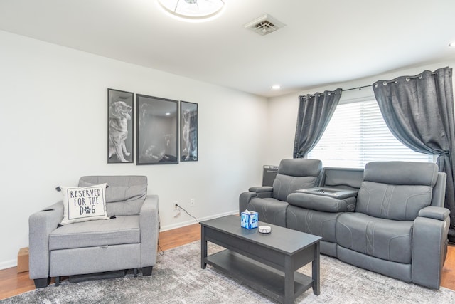 living area featuring recessed lighting, wood finished floors, visible vents, and baseboards