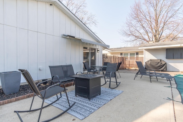 view of patio / terrace with fence, a grill, and an outdoor fire pit