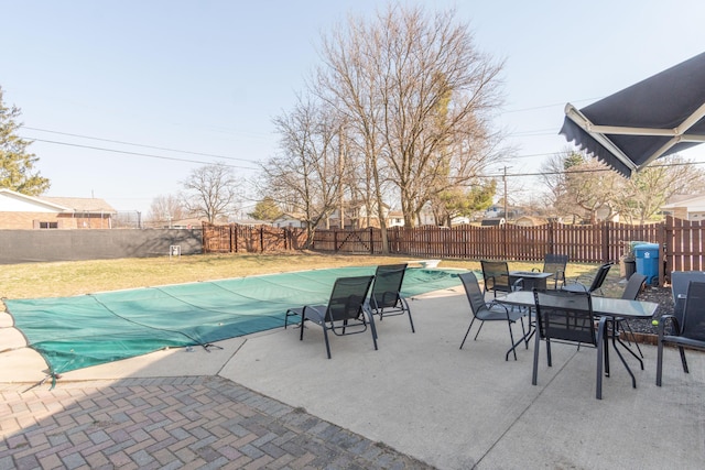 view of patio with a fenced in pool, a fenced backyard, and an outdoor fire pit