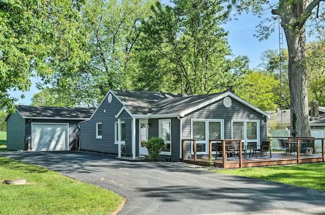 ranch-style house with aphalt driveway, an attached garage, and a wooden deck