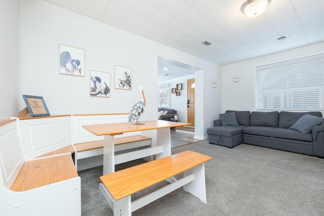 living area with dark colored carpet