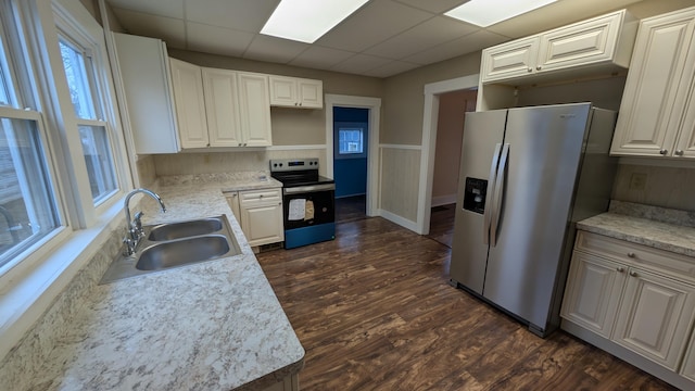 kitchen featuring stainless steel appliances, sink, dark wood-type flooring, and white cabinets