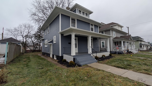 view of front of home featuring covered porch and a front yard