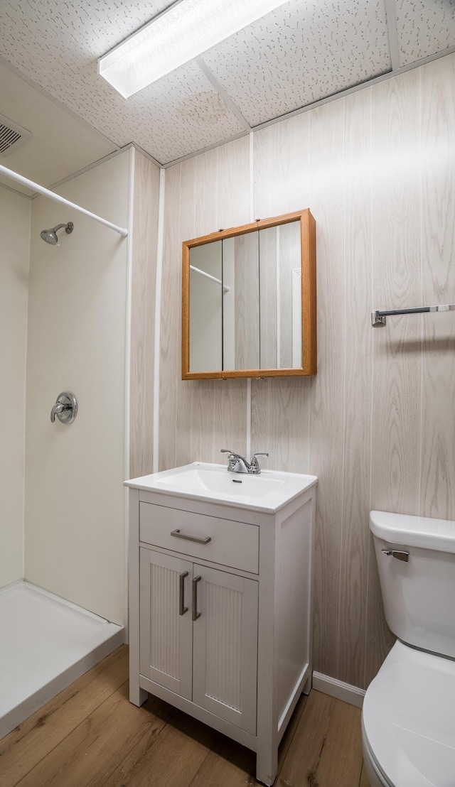 309 Staunton St, Piqua, OH 45356 - full bathroom featuring vanity, toilet, wood finished floors, and a shower