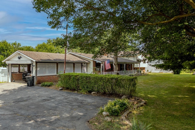 302 N W St, Arcanum, OH 45304 - view of front of property with asphalt driveway, an attached carport, and roof with shingles