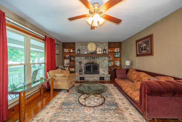 302 N W St, Arcanum, OH 45304 - living area featuring wood finished floors, a ceiling fan, a fireplace, and a textured ceiling