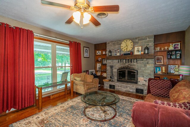 302 N W St, Arcanum, OH 45304 - living area with a fireplace, a textured ceiling, wood finished floors, and ceiling fan