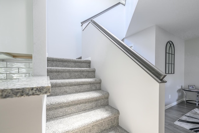 11531 Circle Dr, Lakeview, OH 43331 - staircase featuring wood finished floors and baseboards