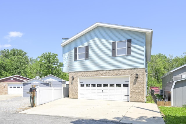 11531 Circle Dr, Lakeview, OH 43331 - view of front of house featuring brick siding, driveway, and an attached garage