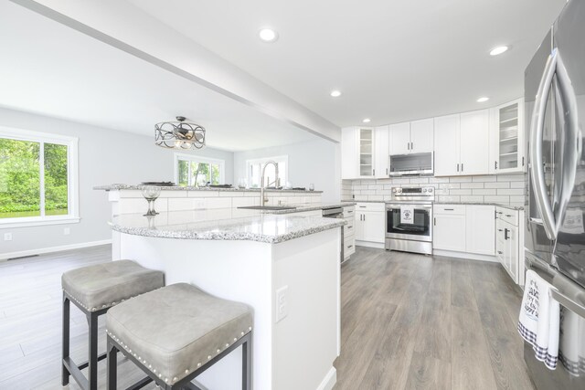 11531 Circle Dr, Lakeview, OH 43331 - kitchen featuring stainless steel appliances, a peninsula, a kitchen breakfast bar, healthy amount of natural light, and recessed lighting