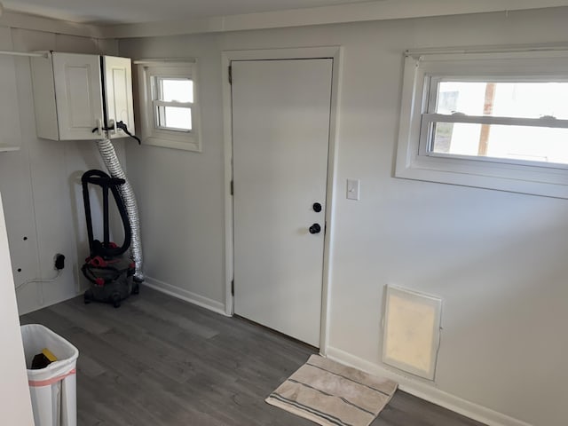 entryway with baseboards and wood finished floors