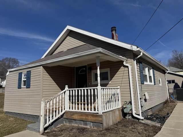 view of front facade with covered porch and central AC