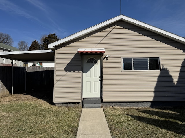 exterior space with a front yard and fence