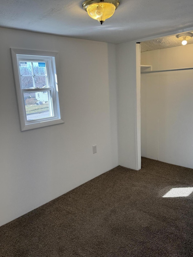 unfurnished bedroom featuring carpet floors and a closet