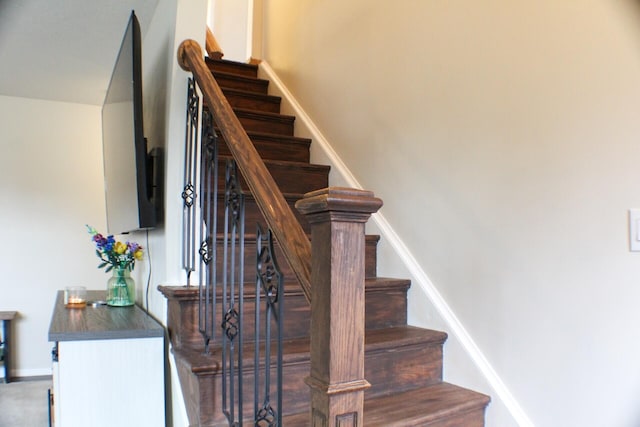 stairway featuring baseboards