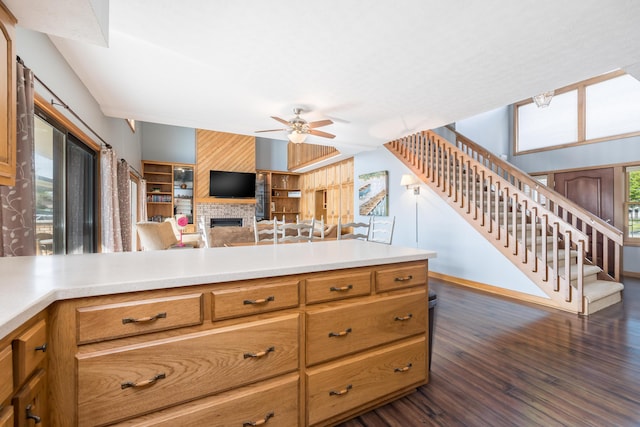 10339 County Road 286 Unit D4, Huntsville, OH 43324 - kitchen featuring a ceiling fan, dark wood-style flooring, a fireplace, and light countertops