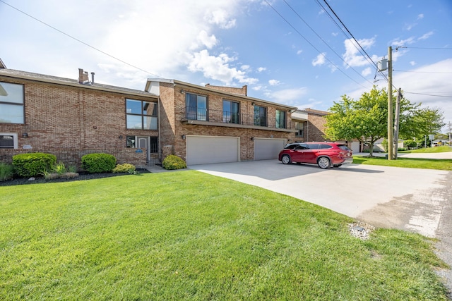 10339 County Road 286 Unit D4, Huntsville, OH 43324 - view of property featuring concrete driveway, brick siding, an attached garage, and a front lawn