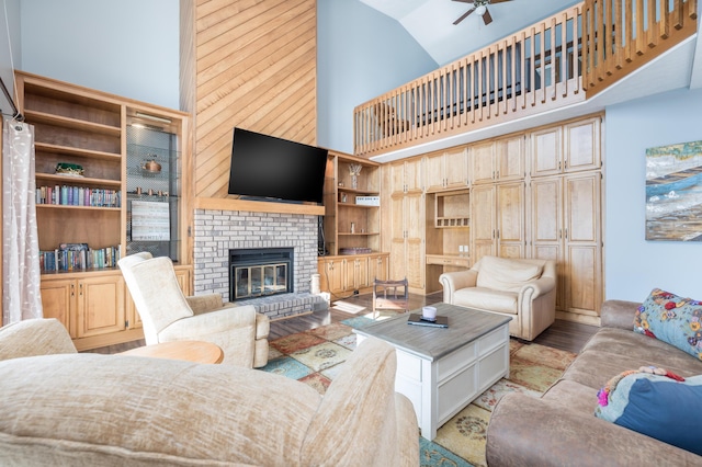 10339 County Road 286 Unit D4, Huntsville, OH 43324 - living area with high vaulted ceiling, ceiling fan, a brick fireplace, light wood-style floors, and built in shelves