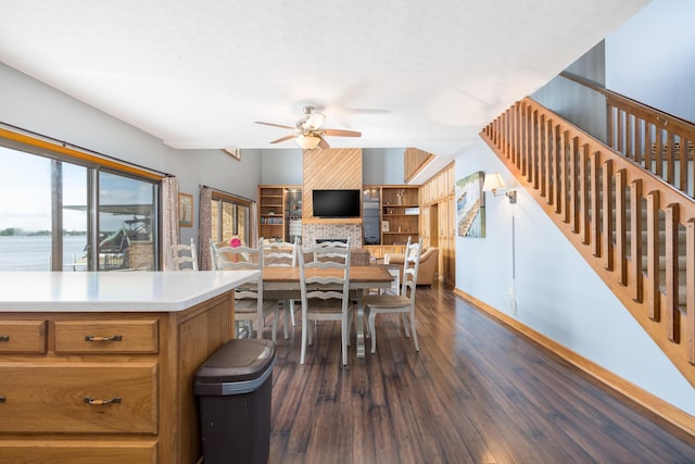 10339 County Road 286 Unit D4, Huntsville, OH 43324 - dining space featuring a ceiling fan, dark wood-type flooring, baseboards, stairs, and a water view