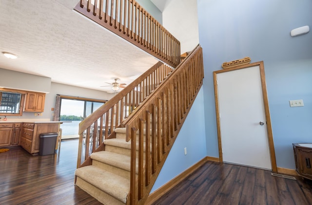 10339 County Road 286 Unit D4, Huntsville, OH 43324 - staircase with wood finished floors, ceiling fan, baseboards, and a textured ceiling
