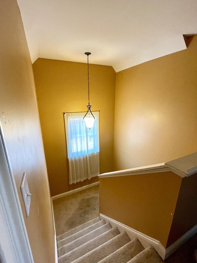 staircase with baseboards, carpet, and lofted ceiling