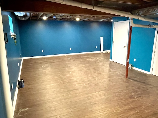 basement with wood finished floors and baseboards