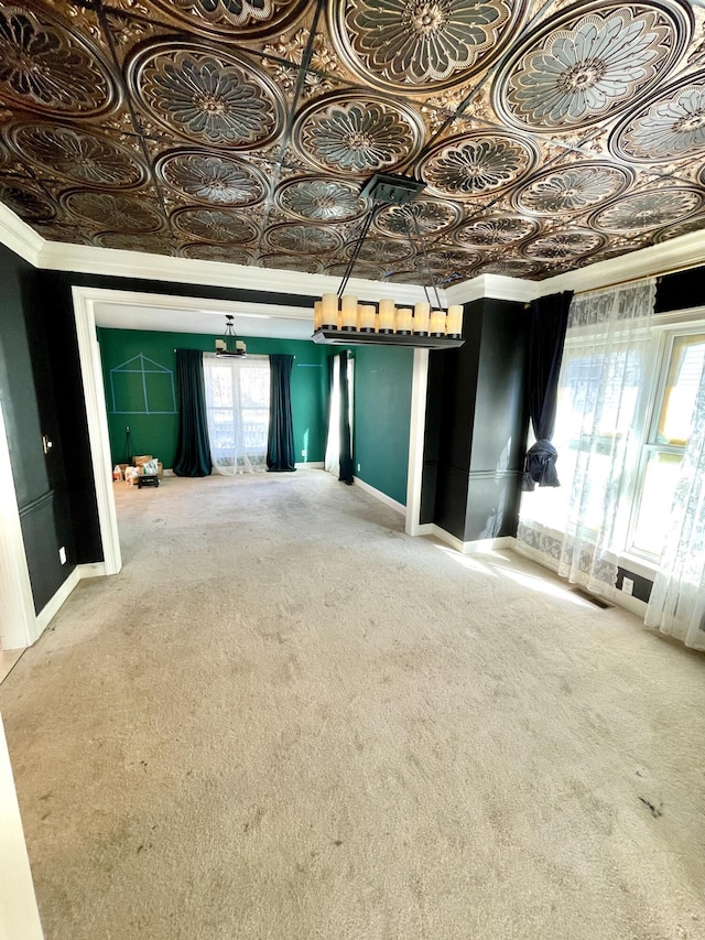 interior space with baseboards and an ornate ceiling